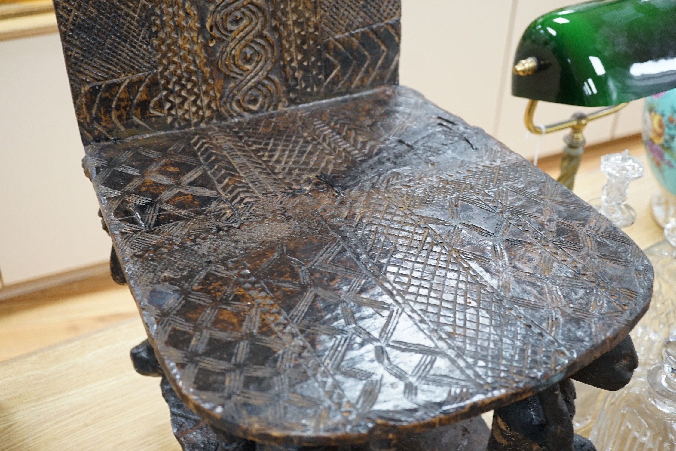 An African tribal carved hardwood chair, possibly Congo. 76cm tall